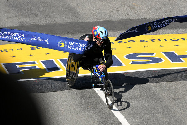 Daniel Romanchuk of the United States crosses the line to win the men's wheelchair race at the 2022 Boston Marathon.